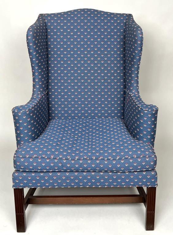Kittinger Chippendale Style Upholstered Wing Chair: marked Colonial Williamsburg reproduction, with stop fluted front legs, stretcher base. 45 3/4" high, 32" wide, 24 3/4" deep; seat height: 18 1/2". Soiling, leg wear.
