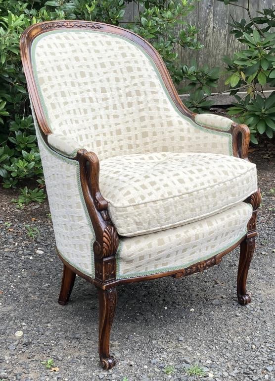 Continental Swan Carved Bergere Chair: with carved exposed wood frame, sloping to swan carved arms above leafage and scrolling carved foot. 19th century. 36" high, 25" wide, 17 1/4" deep; seat height: 20". Wear to finish.