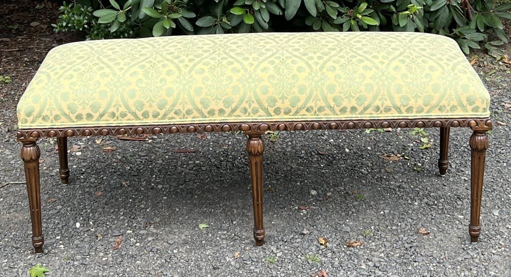 Louis XVI Style Upholstered Bench: six legged design, turned fluted and leaf carved legs, egg and dart carved exposed frame. 19" high, 49 1/2" wide, 18" deep.