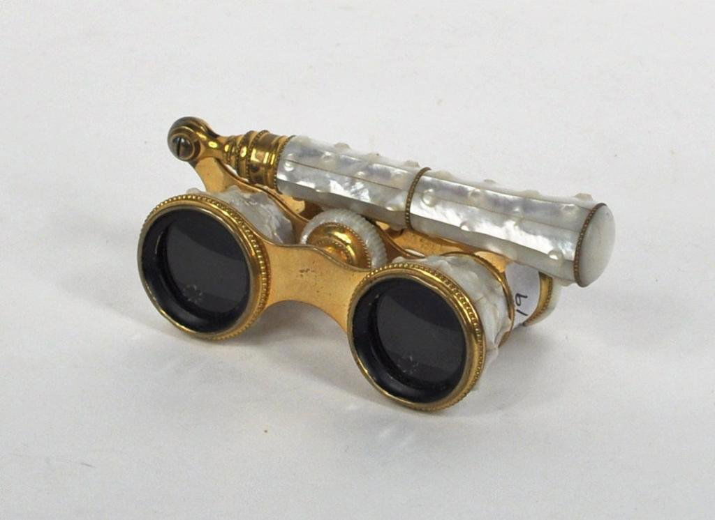 Fine Pair Brass and MOP Opera Glasses: Fine pair of brass and mother of pearl opera glasses, with handle and beaded detail, marked Lemaire Paris, later 19th century/early 20th century. 4 1/2" high, 4 1/2" wide, 2" deep.