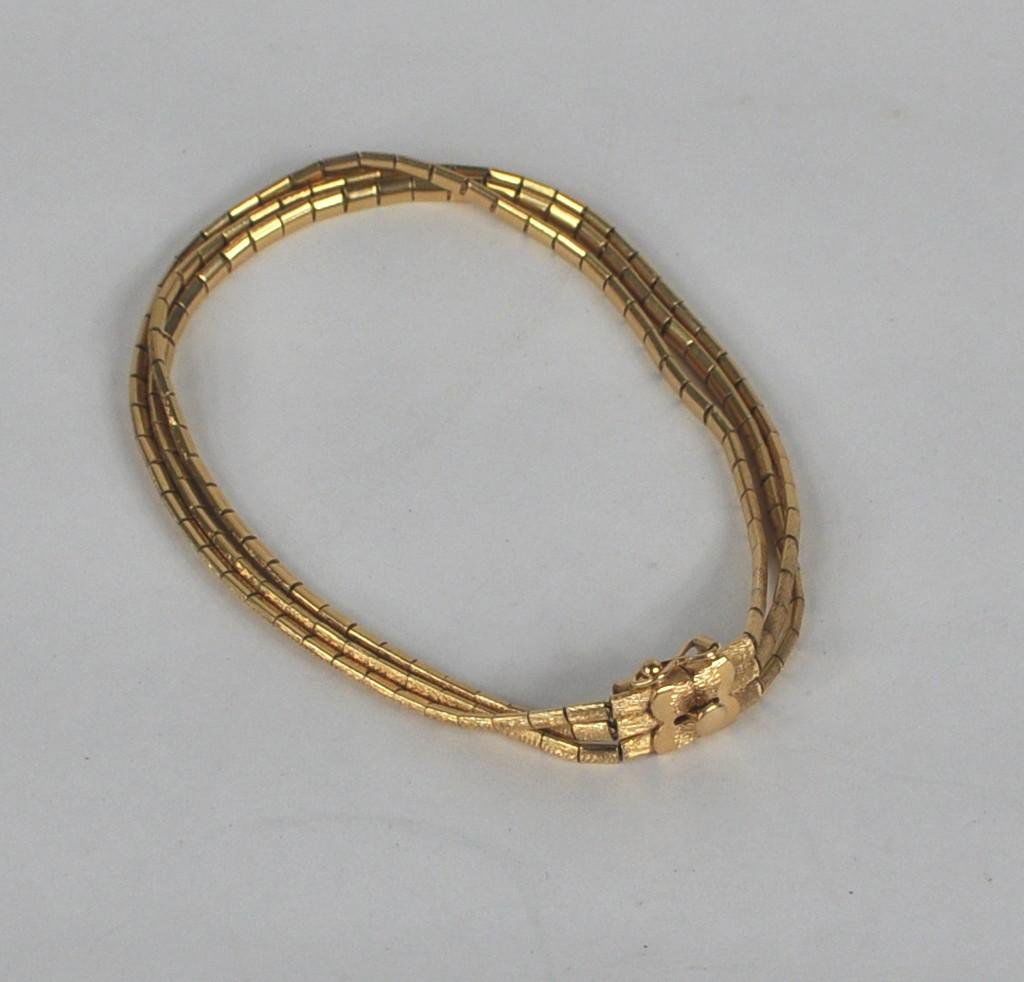 18K Gold Three Strand Bracelet: An 18K gold three strand snake chain bracelet of jointed brushed links, marked "750 - 86VI". Approximately 7 1/2" long. 14.5 dwt. Most likely made in Italy.