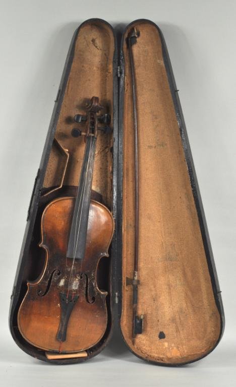 Vintage Copy of a Stradivarius Violin: Vintage copy of a Stradivarius violin, paper label "Copy of Antonius Stradivarius made in Germany", in a wooden case. Poor condition, varnish wear, warping and splitting, together with a vintage bow i