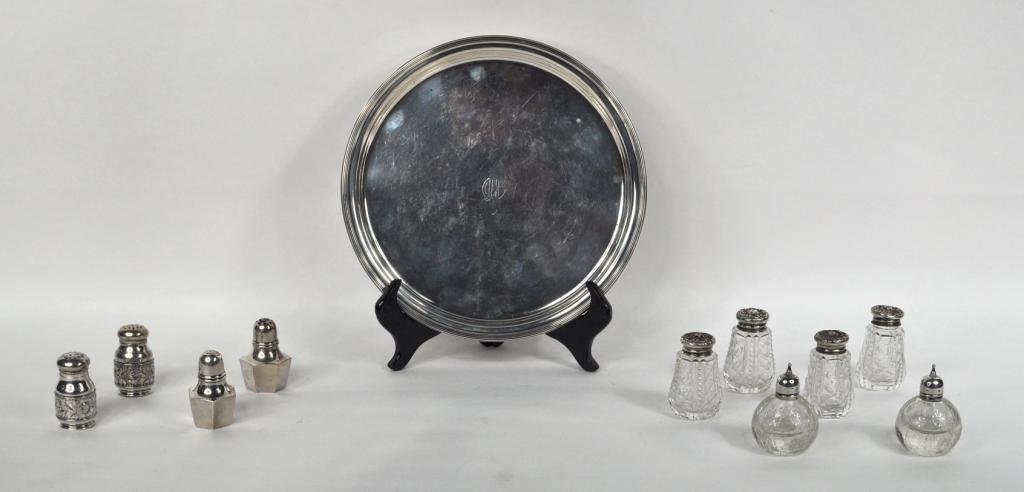 American Sterling Silver Serving Tray, Shakers: American round sterling silver serving tray by Mauser Mfg. Co., monogrammed with raised rim edge, together with a set of four glass shakers with silver lids, a pair of silver shakers, and a pair of si