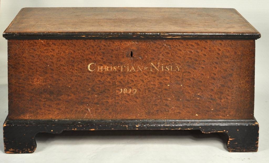 Pennsylvania Chippendale Decorated Blanket Chest: Pennsylvania paint decorated chippendale lift top blanket chest with bracket feet, inscribed and dated "Christian Nisley - 1819". 24 1/2" high, 51 1/2" wide, 22 3/4" deep. Nisley is listed in 1800 and