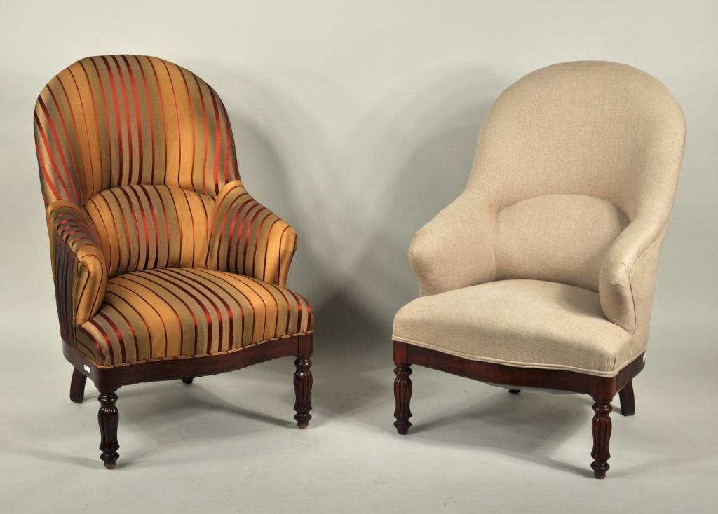 Pair of Sheraton Style Upholstered Bergere Chairs: A pair of sheraton style upholstered mahogany bergere chairs with high, arched backs and shaped arms, set on turned and reeded front legs, one newly upholstered in silk fabric, the other upholstered i