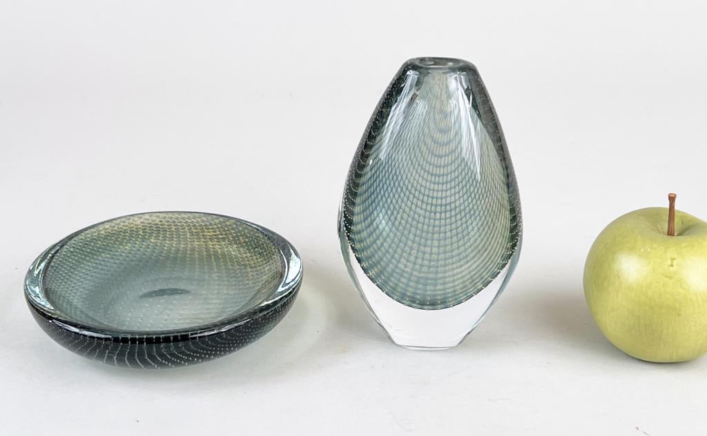 Two Kraka Sven Palmqvst for Orrerfors Glasswares: comprising a tear drop form vase and a dish. Vase: 6" high, 3 1/2" wide, 2 1/4" deep. Dish: 5 5/8" diameter. Wear to bottoms of bases, vase with scratch on side.