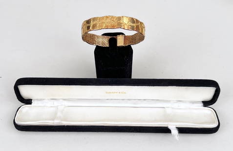 French Tiffany 18K Gold Bracelet: semi-flexible with reptilian pattern, marked "Tiffany 18kt France" with black velvet Tiffany box. 7 1/8" long closed, 1/2" wide. 33.7 DWT. *No credit card payments will be accepted for silver, gold,