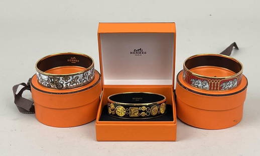 Three Hermes Enamel Bangles: comprising Grand Apparat, horse and carriage and Imprimes (equestrian horses). All with boxes. 2 3/4" diameter. 7/8" wide; varying slightly in size (approximately 1/16"). Light use wear, Imprimes with