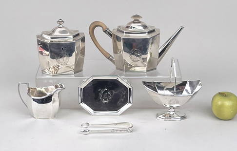 English Sterling Five Piece Tea Set: marked for London, William Fountain maker, with armorial crests and personalized 1922 on bottom of base. Comprising teapot, creamer, sugar bowl with strap handle, a footed stand, and a tea box (tea ca