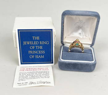 Princess of Siam 14K Gold Ring: Franklin Mint "The Jeweled Ring of the Princess of Siam". 14k gold set with 23 gemstones including a five point diamond, an emerald, two sapphires and 15 rubies. Approximate size: 9 1/2. Gross weight: