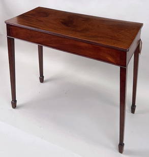 English Late George III Mahogany Side Table: with reeded top edge, veneered apron and square tapering legs ending in spade feet. 31 1/2" high, 42" wide, 19 1/2" deep. Expected age and use wear. Old finish.