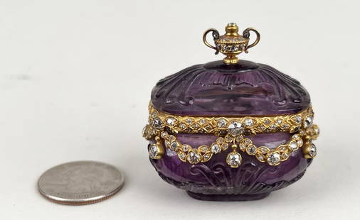 Amethyst Gold Mounted Rose Diamond Snuff Box: probably French mid-late 18th c., cut with scrolls from one amethyst, the rim set with with rose diamonds and swags with hinged lid and diamond set urn finial. Signed with a stylized T and globe. 1 7/
