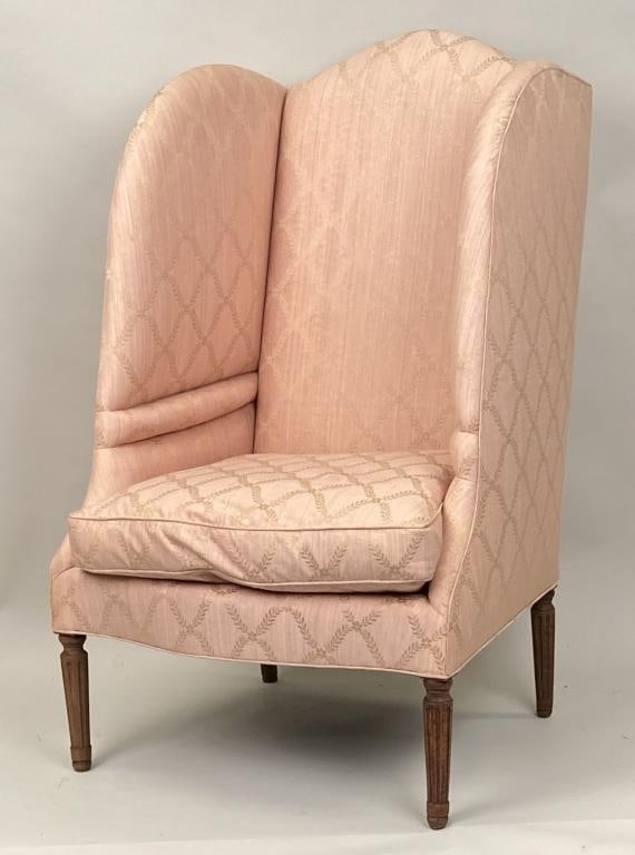 Louis XVI Style Upholstered Wing Chair: in very nice fabric with cushion; deep wings and shaped seat, turned and fluted legs. 44" high, 29" wide, 24" deep, 18" seat height. Repair to one front leg, other slightly loose, upholstery in good c