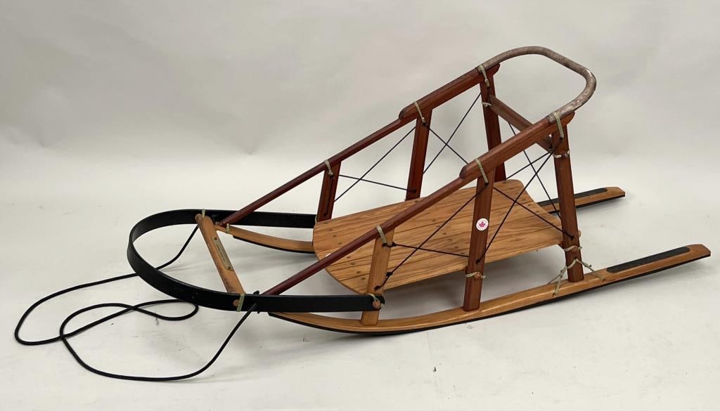 French Canadian Dog Sled: oak, metal and wire construction, circa 1960's. Label and tag "Made In Canada". 21 1/4" high, 54 1/2" wide, 15 3/4" deep. Expected age and use wear.