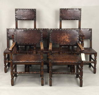 Set Eight Antique Jacobean Style Oak Dining Chairs: with leather upholstery and large brass studs, comprising six side chairs and two arm chairs. 37 1/2" high, 22" wide, 19" deep, 18" seat height. Age and use wear, some scuffs to leather, a couple tear