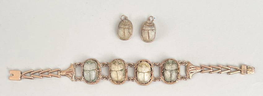 Egyptian Revival Gold Scarab Bracelet: carved stone scarabs set in lotus flower design bracelet; together with two pendants, or possible earrings. Bracelet: 7 1/2" long, 7/8" wide. Gross weight of bracelet: 16.7 DWT. *No credit card paymen