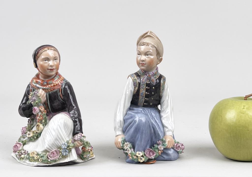 Two Royal Copenhagen Amager Figurines: designed by artist Carl Martin Hansen (1877-1941). Larger: 5 1/2" high, 3 1/2" wide, 3 1/2" deep.