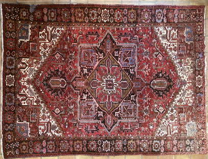 Persian Heriz Carpet: room size rug, 20th century. 9' 2" wide,12' 2" long. Wear, fading, some bare spots from rot as shown, water damage. All rugs sold as is.