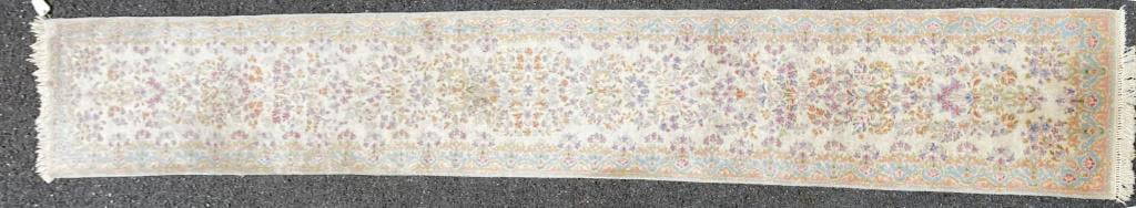 Persian Kerman Runner: with ivory ground, overall floral design. Label "Royal Carpets-Imperial Kerman". 31" wide, 16' 7" long. All rugs sold as is. Some small staining, fringe loss at one end.