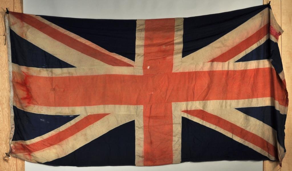 Vintage "Union Jack" British Flag: Large vintage "Union Jack" British flag, probably turn of the century or earlier, in poor condition. 5'10" high, 11'3" wide.