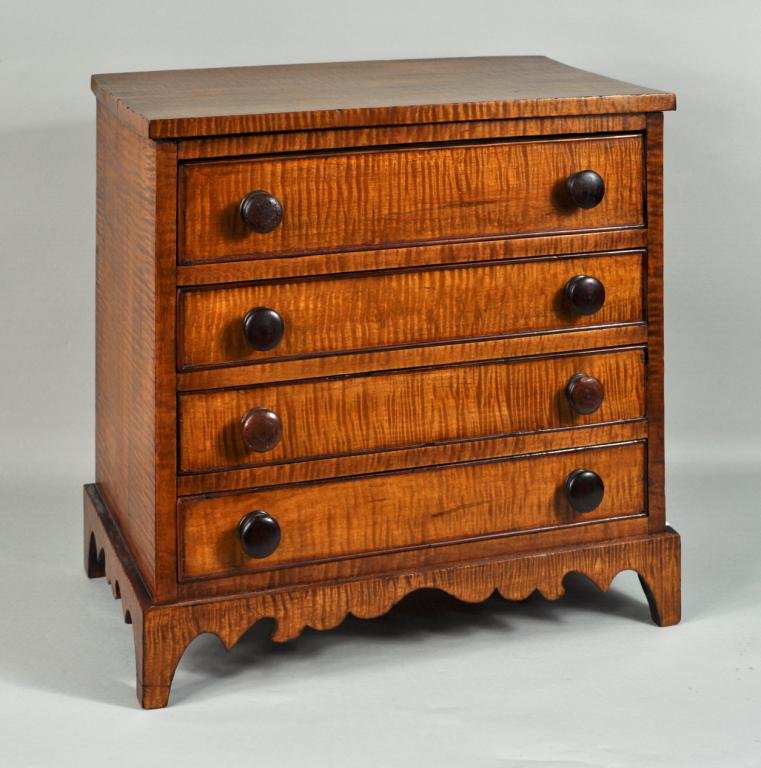 Miniature Tiger Maple Chest: Miniature hepplewhite style tiger maple four drawer chest, having cutout base. 17 1/2" high, 18 1/2" wide, 10 1/2" deep.