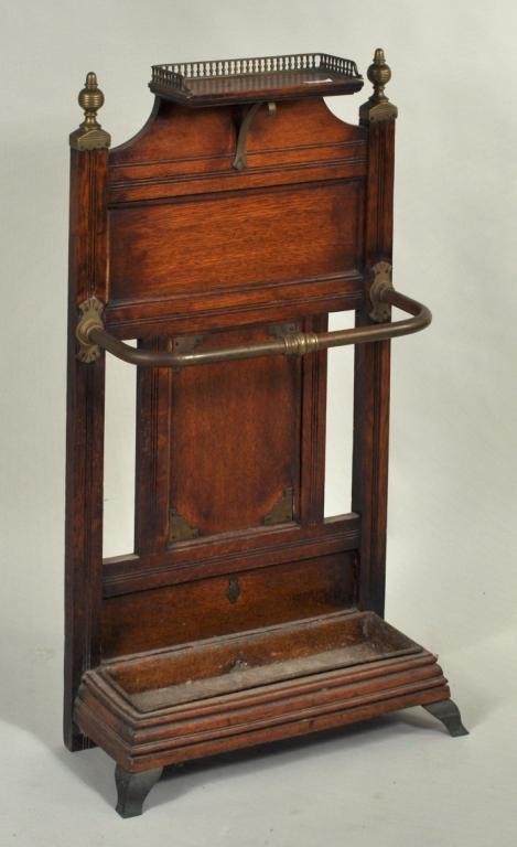 Victorian Brass Mounted Oak Umbrella Stand: Victorian (or Edwardian) brass mounted oak umbrella stand, paneled oak with brass gallery, rail and finials, and molded base. 39 3/4" high, 22" wide, 10" deep.