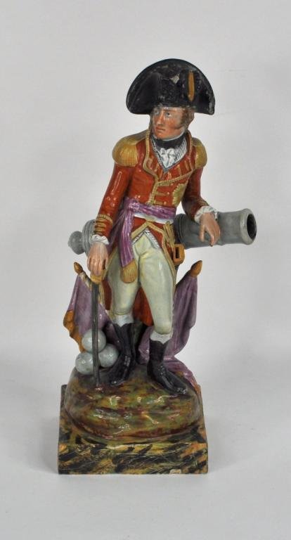 Staffordshire Figure, Duke of Wellington: A fine Staffordshire figure of the Duke of Wellington, finely modeled and painted, depicted standing leaning on a cannon with military trophies. Signed indistinct at the base, old losses to hat and ba