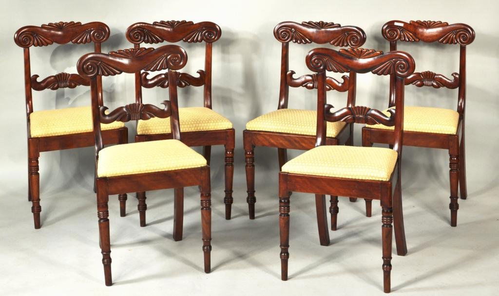 Set of Six Regency Style Mahogany Dining Chairs: Set of six Regency style carved mahogany dining chairs, with carved shaped crests, horizontal carved splat and slip out seats above turned front legs. 33 3/4" high, 18" wide, 19 1/4" deep.