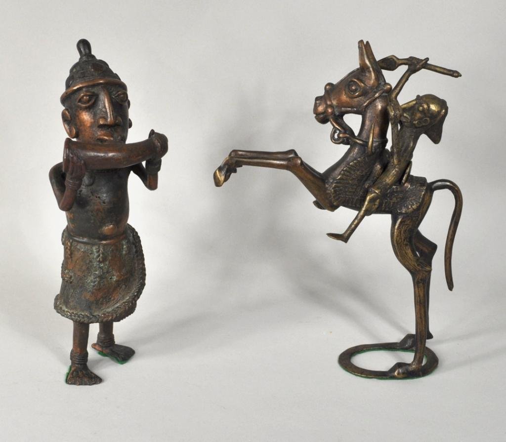 Two African Patinated Bronze Figures: Two African patinated bronze figures, one modeled in cap and tunic sounding a horn, the other a horse and rider (3 pieces total). Largest: 11 1/4" high, 8 1/2" wide 3" deep; smallest: 11 1/2" high, 4 