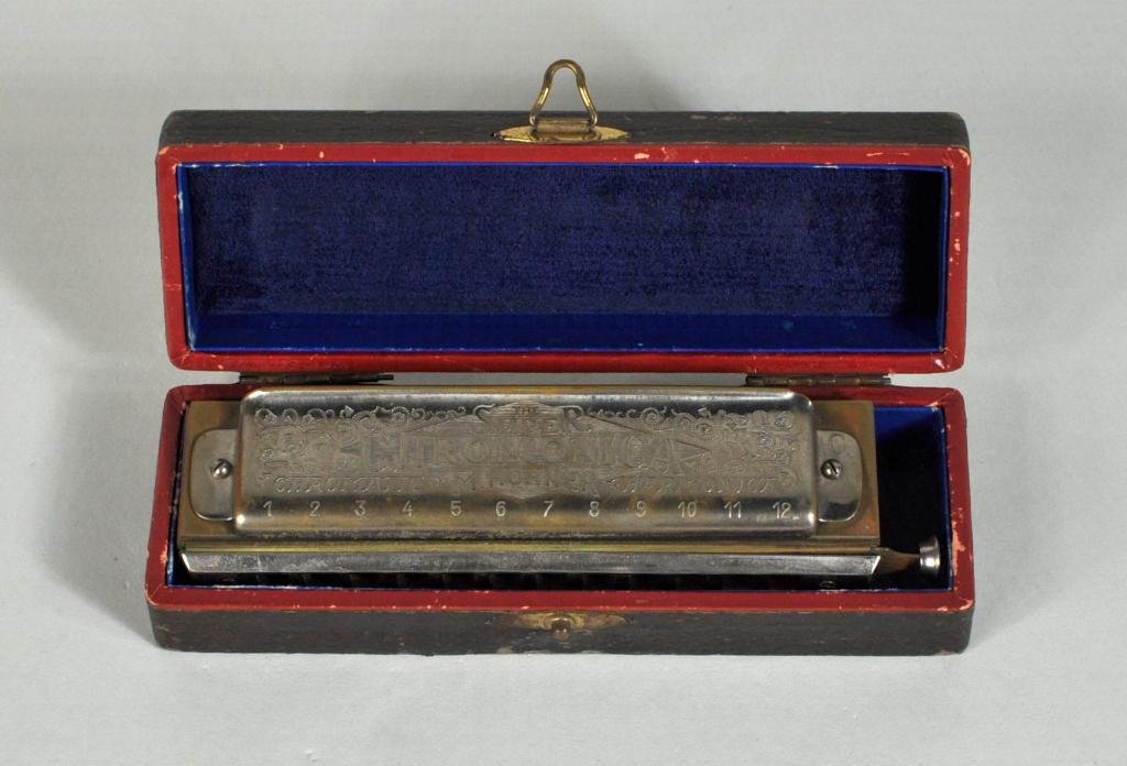 Vintage Hohner Chromatic Harmonica: Fine vintage Hohner chromatic harmonica, "The Super Chromonica" in "C" in its original hard case with paper label. 1 1/2" high, 6 1/2" wide, 2" deep.