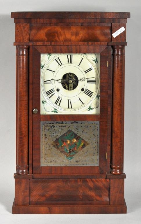 Seth Thomas Classical Mahogany Mantle Clock: Seth Thomas classical form mahogany mantle clock with turned pilasters and floral decorated eglomise panel (worn) and bearing original label. 25" high, 15" wide, 4 1/2" deep
