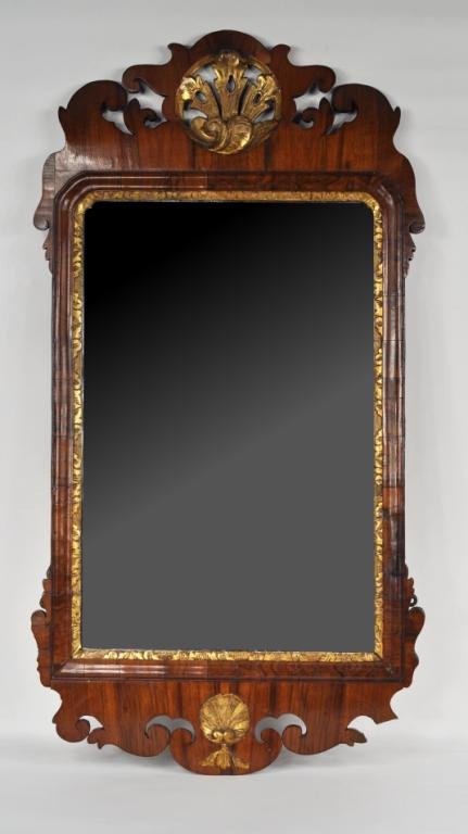 Period Queen Anne Walnut Parcel Gilt Mirror: Queen Anne parcel gilt walnut mirror, with scrolled and notched crest centering a pierced, carved roundel, scrolled apron centering a shell and with rectangular mirror plate set within a molded frame 