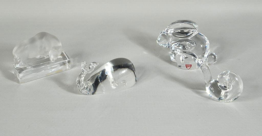 Group Four Art Glass Items: Group of four glassware items, comprising a Lalique bull, a Steuben whale and snail, and an Orrefors rabbit. Largest: 3 1/2" high, 4 1/4" wide, 1 1/2" deep; smallest: 3 1/4" high, 3 1/4" wide, 1 1/2"