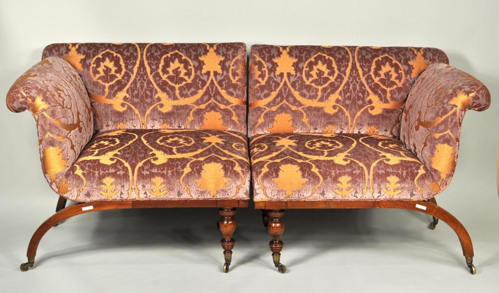 Curule Base Regency Style Mahogany Two Part Settee: Unique Regency style mahogany two part curule base settee, with upholstered seat and back, turned central legs and arched curule end legs, usable in a corner configuration. 33 3/4" high, 78" wide, 27 