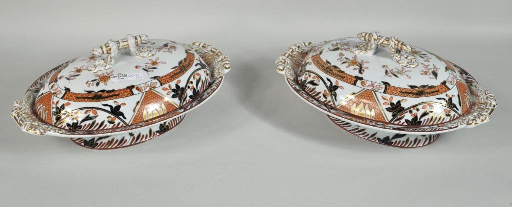 Pair of Ashworth Ironstone Covered Dishes: Pair of Ashworth ironstone covered dishes, orange and black Imari pattern with rope form handles, impressed mark to underside of lids, the bases with printed royal crest. Each 5" high, 13" wide, 9" de