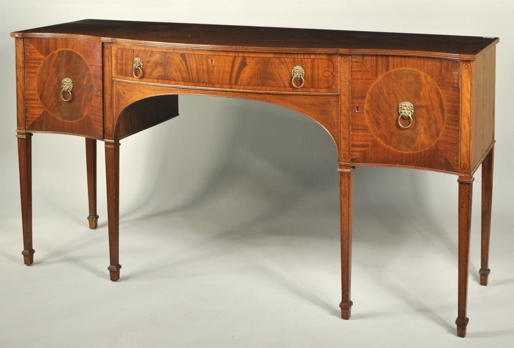 Sheraton Style Inlaid Serpentine Sideboard: Sheraton style inlaid mahogany serpentine sideboard, with doors and drawers, raised on tapering inlaid legs. 37" high, 71 1/2" wide, 24" deep.