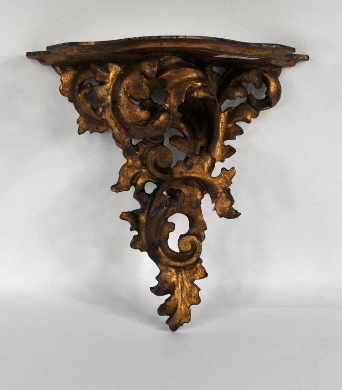 Carved Giltwood Rococo Form Wall Bracket: Carved giltwood rococo form wall bracket, with small areas of loss and old repairs evident. 10 1/2" high, 10 3/4" wide, 5 3/4" deep.
