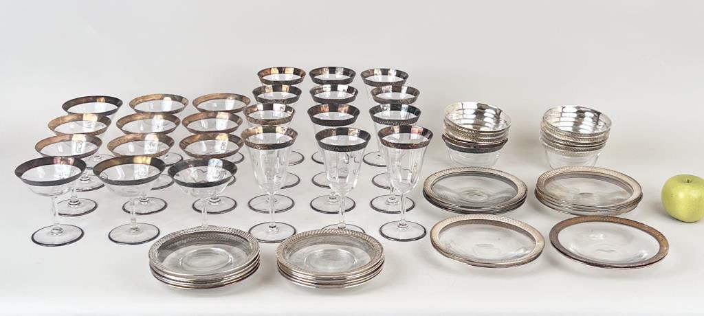 Group Hammered Sterling Mounted Glassware: comprising twelve champagne coupes, twelve bowls, twelve saucers, twelve wine glasses, twelve plates. Largest: 6 1/2" high, 3 1/2" diameter. Oxidation, light use wear, minor scuffing to bottom of base