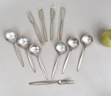 Twelve Pieces Georg Jensen Sterling Flatware: comprising six spoons, two prong fork and four spreaders in the Cypres / Cypress pattern designed by Tias Eckhoff in 1953. Largest: 8 1/4" long. Weight: 16.785 OZT (including plastic bag knives are in