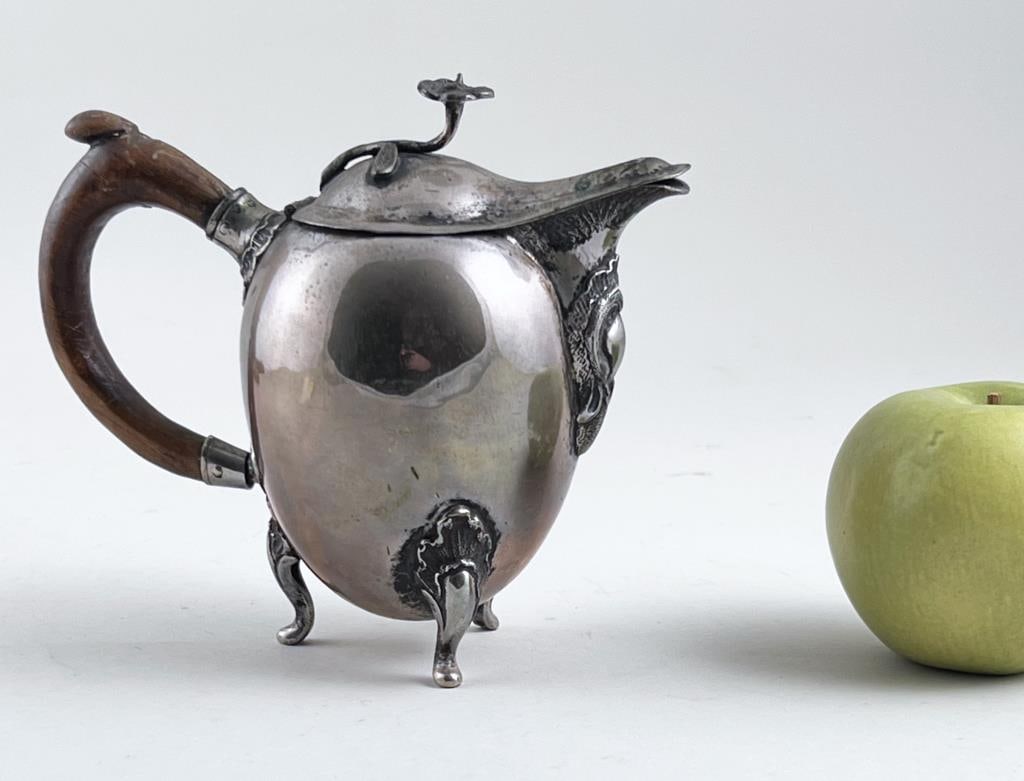 Romanian Egg Form Silver Creamer: with flower finial. Appears to be signed with the Romanian crown hallmark and "L" of Muntenia, tests for silver, likely 800. 5 7/8" high, 6" wide inclusive of handle, 3" deep. Gross weight: 13.72 OZT.