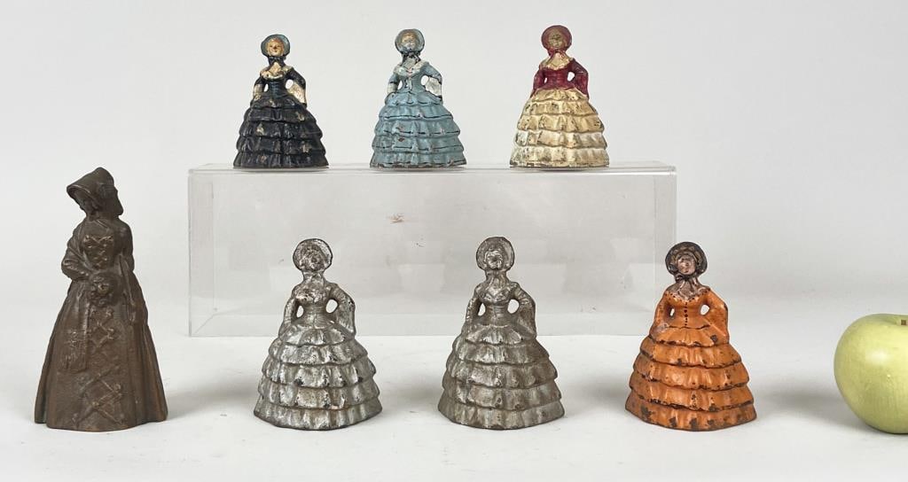 Seven Victorian Painted Cast Iron Figure Doorstops: Southern Belle form of finely attired ladies. Largest: 6 1/2" high, 3 1/4" wide, 2 5/8" deep. Paint losses, age and use wear.