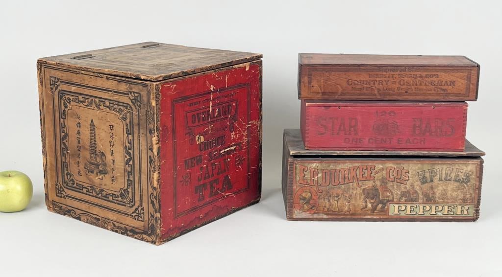 Four Wooden Dry Goods Advertising Boxes: comprising New Seasons Japan Tea, Country Gentleman Cigars, Star Bars and Durkees Pepper. Largest: 11" high, 11" wide, 11" deep. Paint losses, scratching, age and use wear.