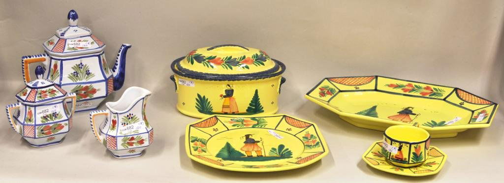 Group of Eight French Quimper Pottery Items: Group of eight French Quimper pottery items comprising a large yellow platter, covered baking dish, dinner plate, cup and saucer, and a white teapot, creamer and covered sugar. Smallest: 2 1/4" high,