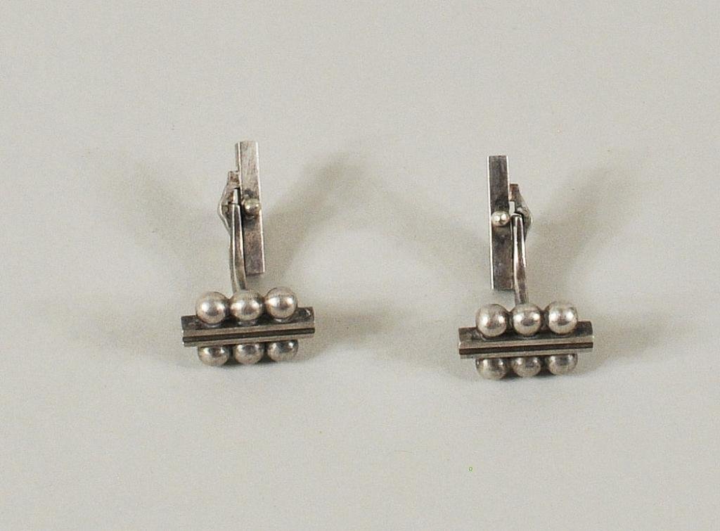 Pair Georg Jensen Sterling Silver Cufflinks: Pair Georg Jensen sterling silver cufflinks, circa 1950, signed with Jensen hallmark, Sterling Denmark and 61B. Designed with a central ridged bar flanked by three balls on each side with swivel back.
