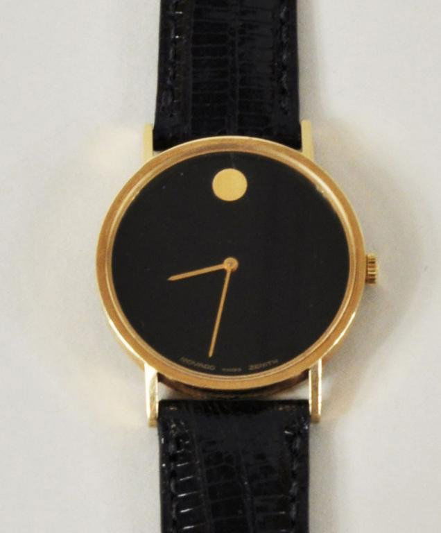 Movado Museum Watch, 14K Gold: Movado Museum watch, 14K gold, with black lizard band, circa 1970s. The case signed Movado Swiss Zenith on the black dial and signed on the back 36 0750 172 14K. Gross weight 30.1 grams, 1 1/4" diamet