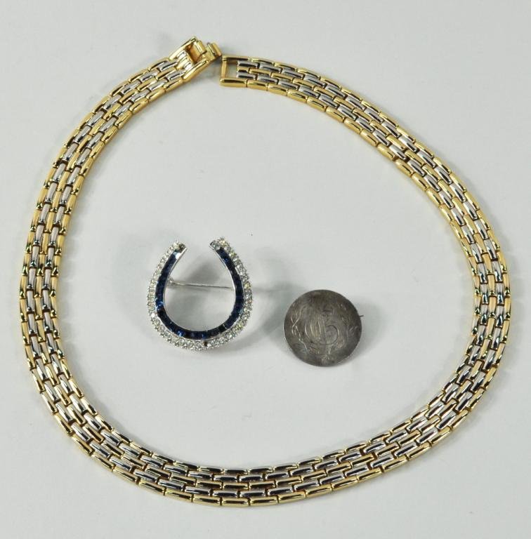 Two Costume Jewelry Items: Two costume jewelry items, 20th century, comprising a Ciner horseshoe pin, a gold link necklace, together with a 19th century silver coin love token. Pin missing one stone. 7/8" diameter to 1/2" wide 