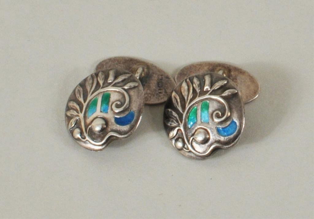 Pair Sterling Silver & Enamel Cufflink: Pair arts & crafts sterling silver and enamel cufflinks by William Hutton & Sons, Birmingham, 1903. The fronts are designed with scrolling vine and three sections of turquiose and green enamel. Hallma