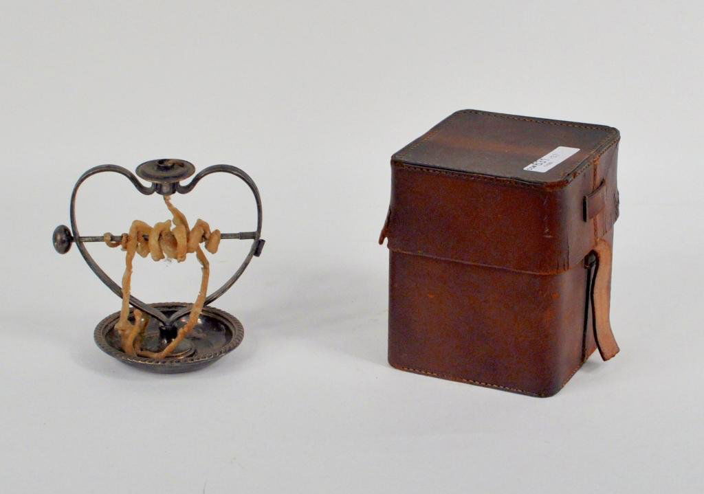 Sheffield Silver Plated Wax Jack: Sheffield silver plated wax jack, heart form in a vintage leather case. Box: 4 3/4" high, 4" wide, 4" deep; jack: 4 1/2" high, 4 1/2" wide, 3 1/4" deep.