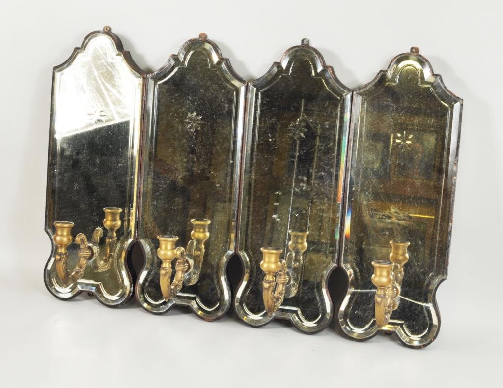 Set of Four Baroque Style Mirrored Wall Sconces: Set of four baroque style cut and beveled mirror glass single candle wall sconces, late 19th century, having a cut star decoration over a brass candle arm. Each 17 1/2" high, 6 1/2" wide, 5 1/2" deep.