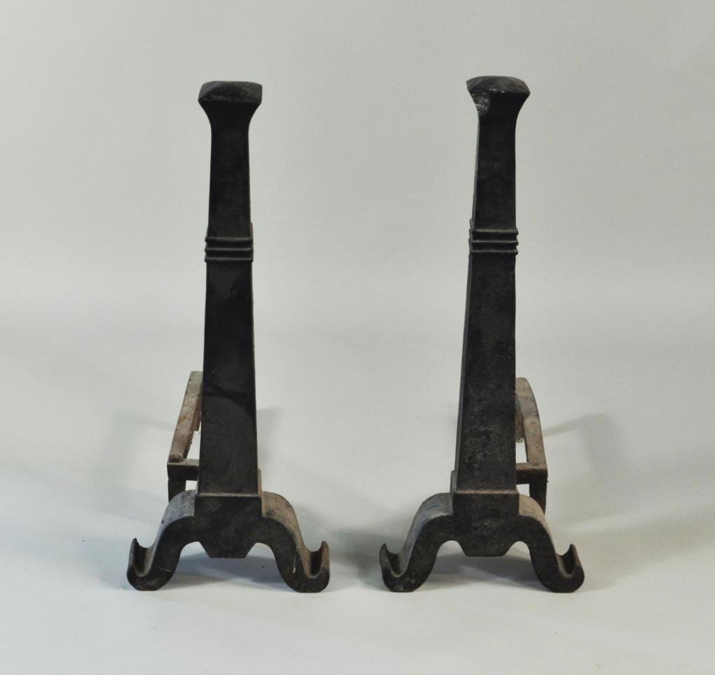 Large Pair Art Deco Columnar Cast Iron Andirons: Large pair of Art Deco style cast iron andirons with square columnar shafts and scrolled bases. 30" high, 12" wide, 23 1/2" deep.